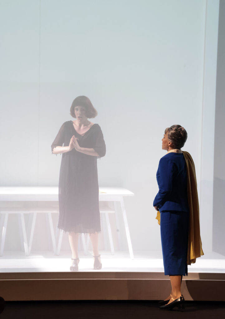 Szenografie von Lisa Behensky für Anna A. – fragmentierter Bühnenraum mit Treppe, mehreren Figuren und weichem Lichteinfall hinter Tüll 